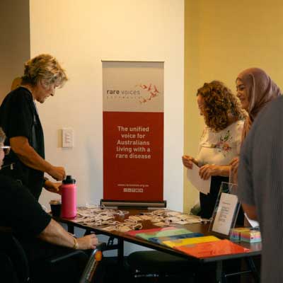 Showcase attendees in front of the Rare Voices Australia banner