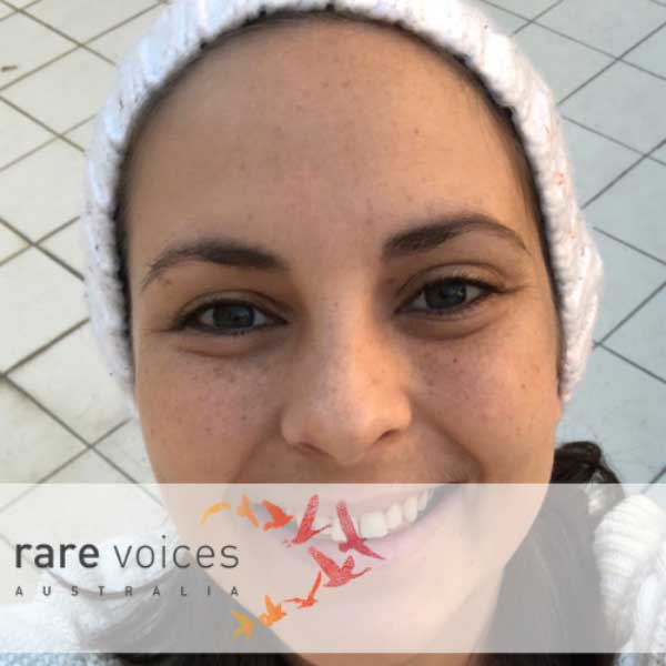Photo of April wearing a beanie and smiling