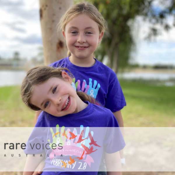 Photo of Ava with her sister. Both wearing Rare Disease Day t-shirts