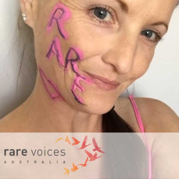 Photo of Jodie with the word 'rare' painted in pink and purple on her face